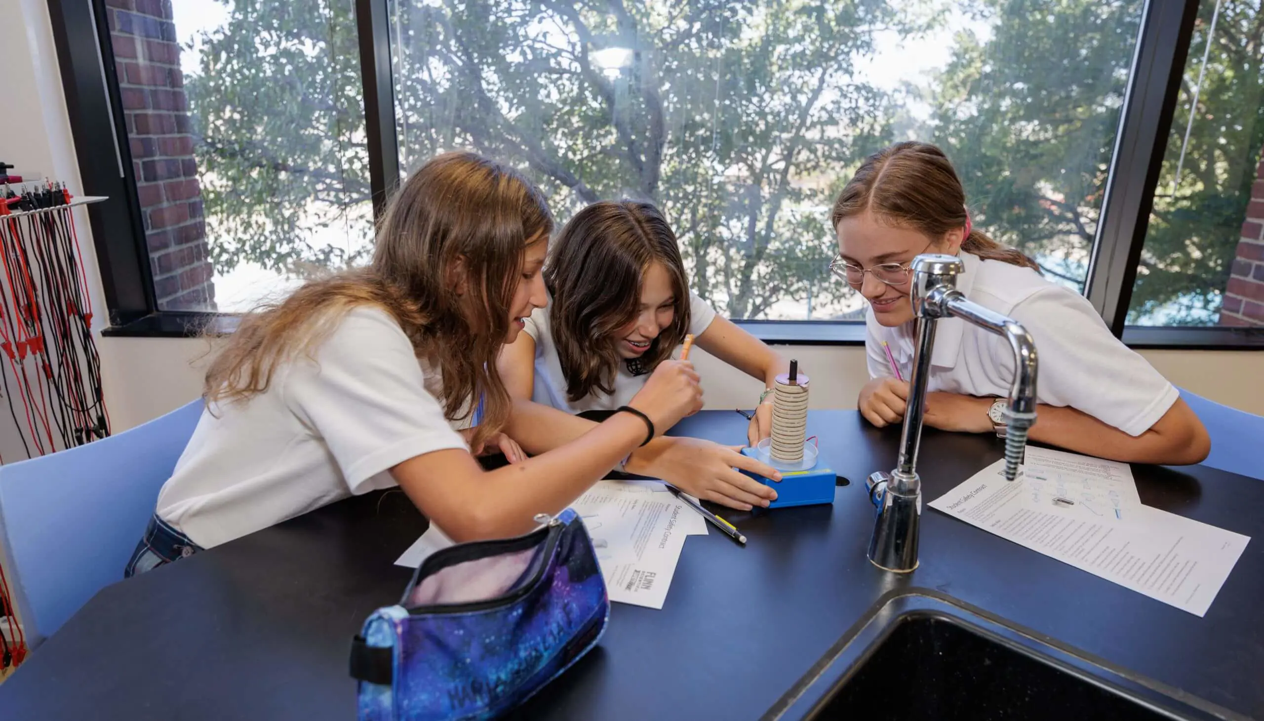 DIS Middle School students conducting an experiment in a science class.