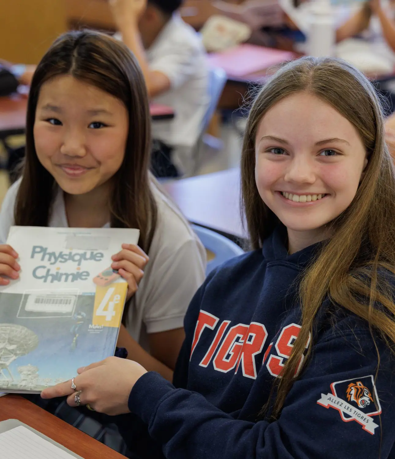 DIS Middle School students reading a book together.
