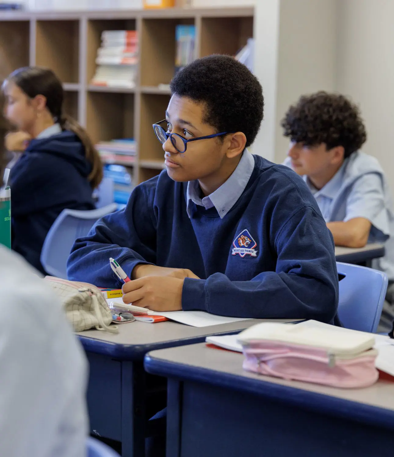 DIS High School student listening attentively to a teacher in class.