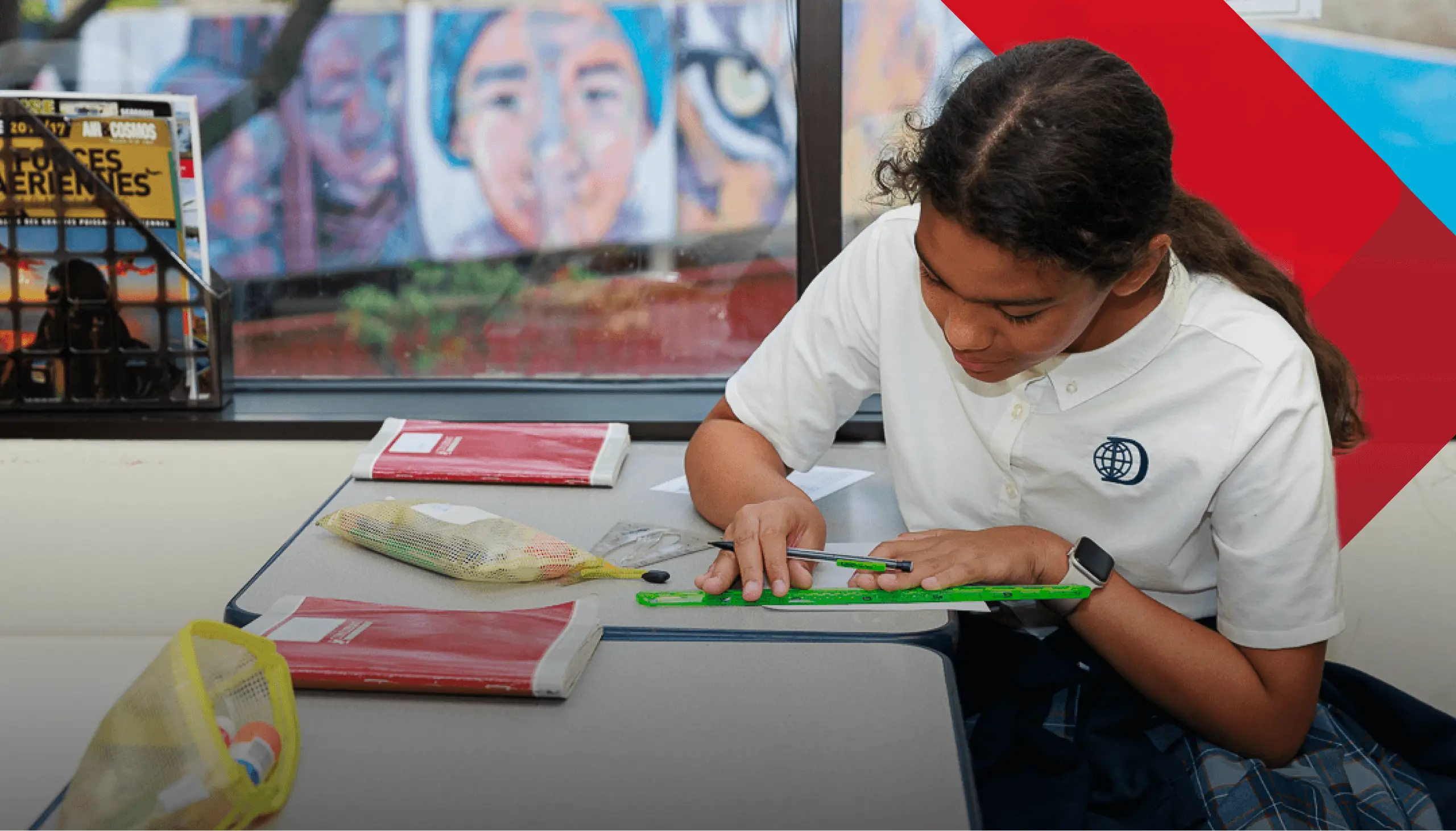 DIS student underlining a title in their workbook with a ruler.