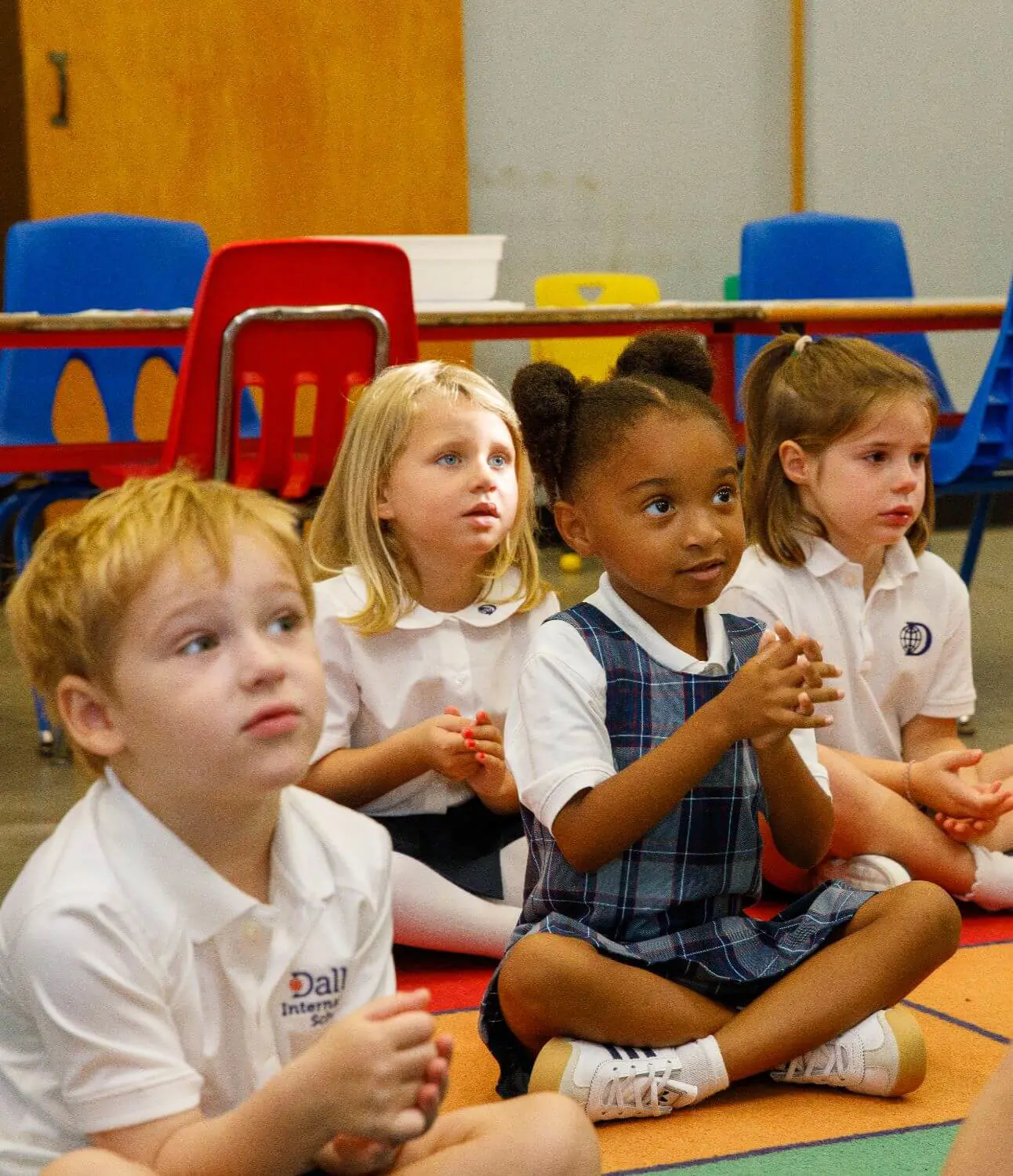 DIS Elementary students sitting together and listening in class.
