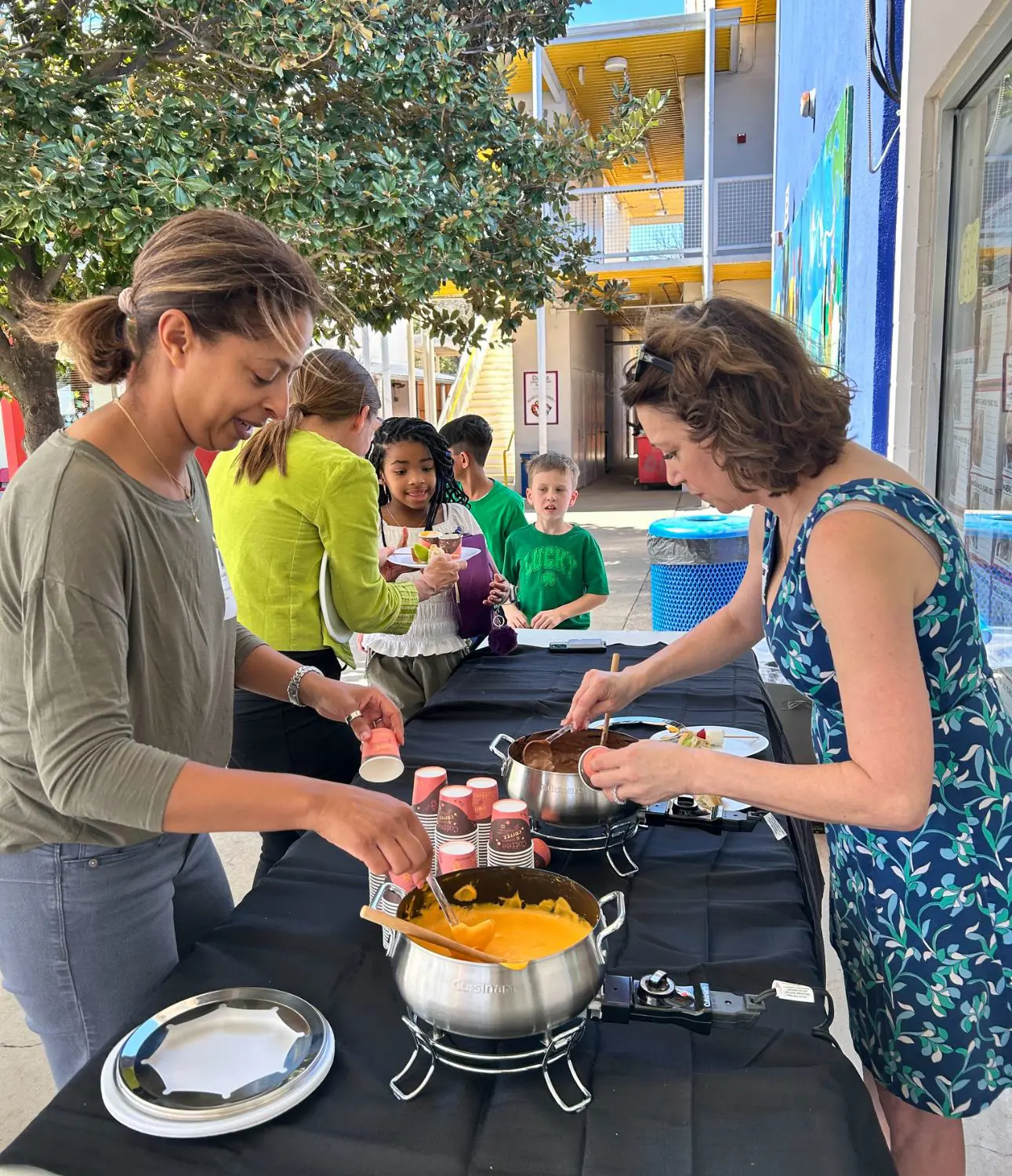 Parents at a buffet during a community event.