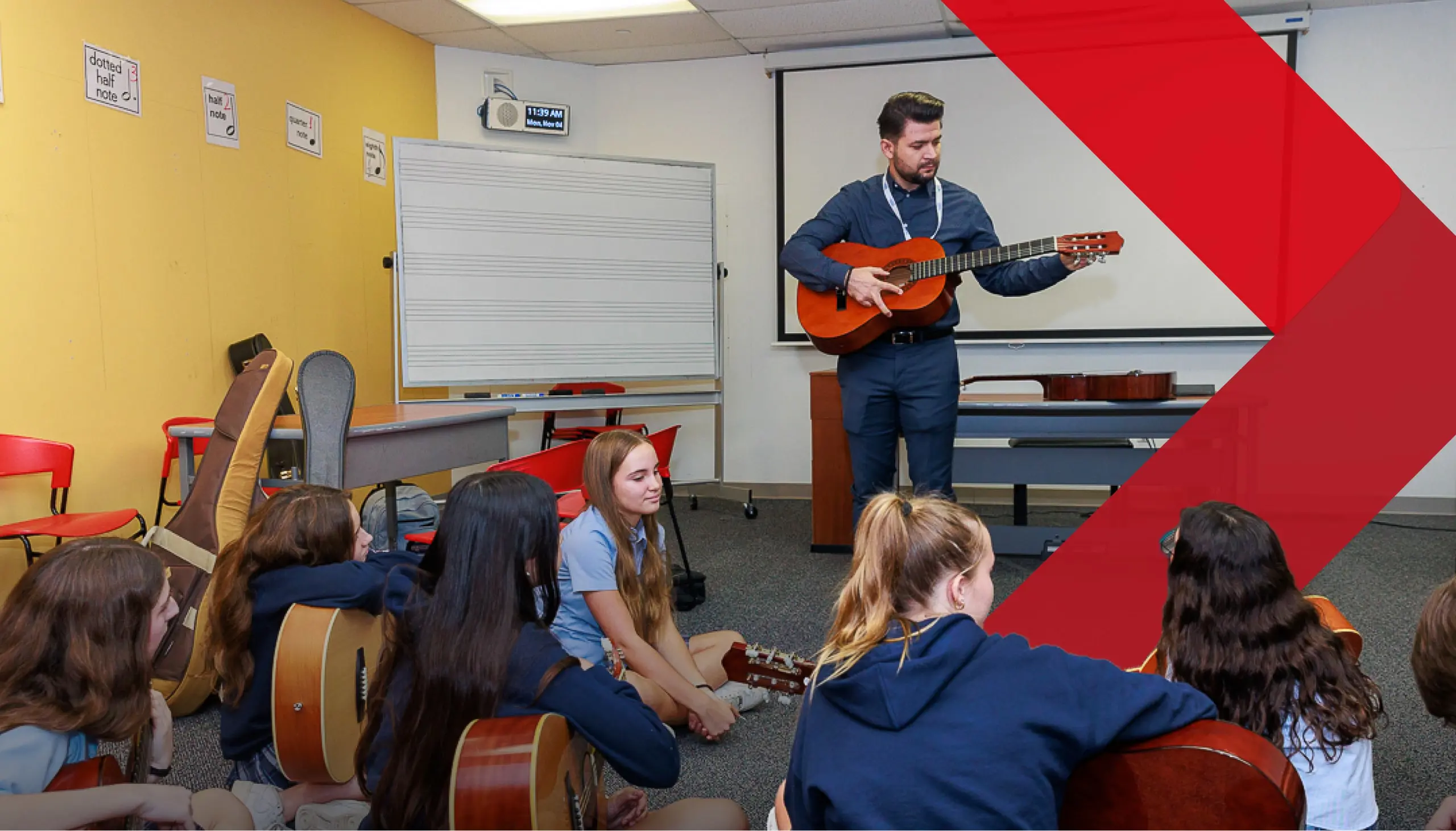 DIS High School students learning guitar in a music class.